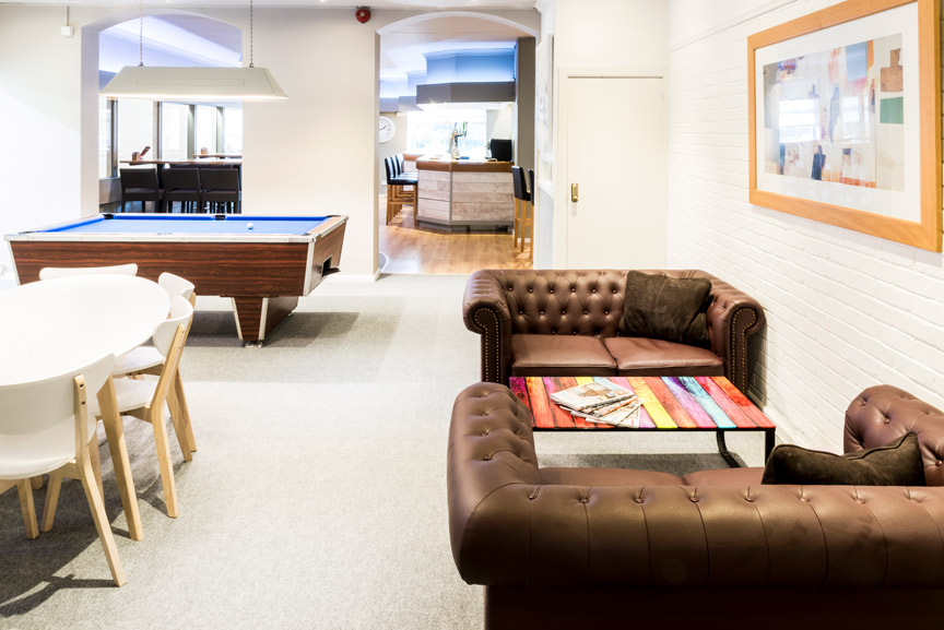 The dedicated waiting area with a bar for coffee and a pool table for games while you wait